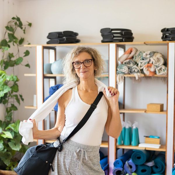 A sequence of yoga mat, water bottle, and a towel neatly arranged.